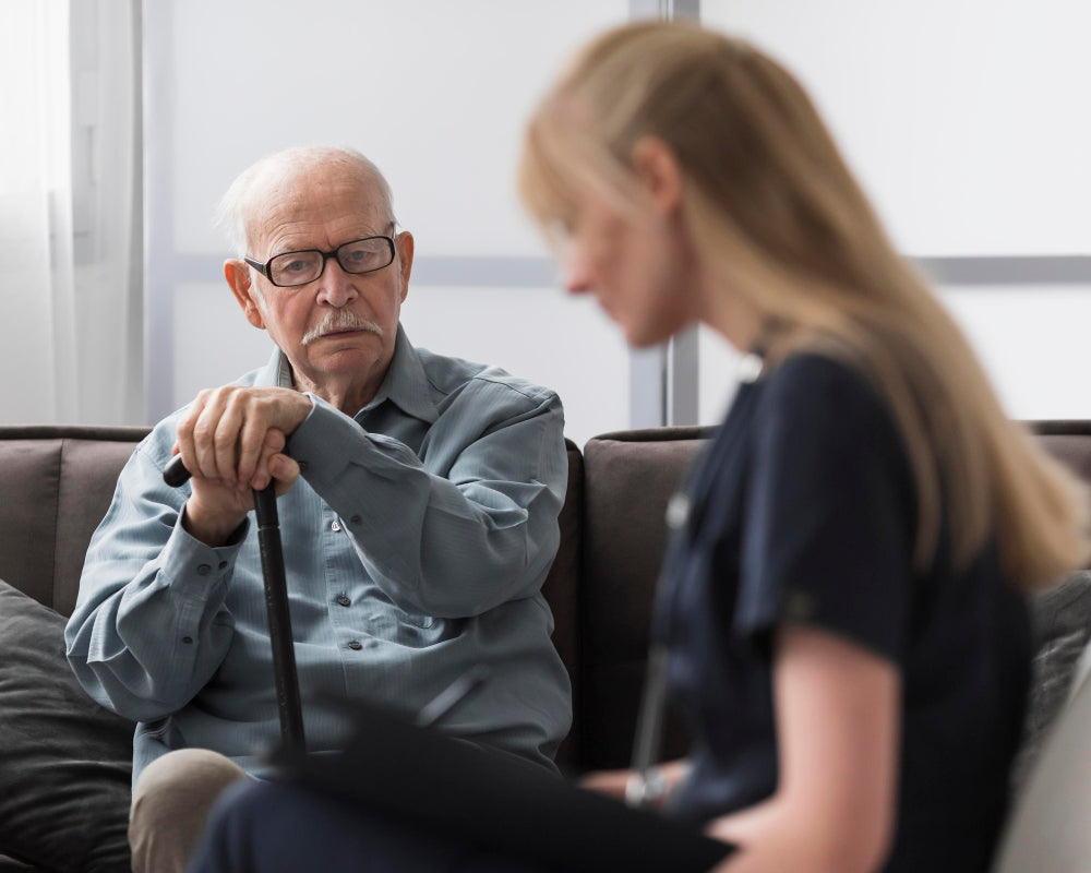 An elderly man being consulted by a nurse in a clinical or home-care setting