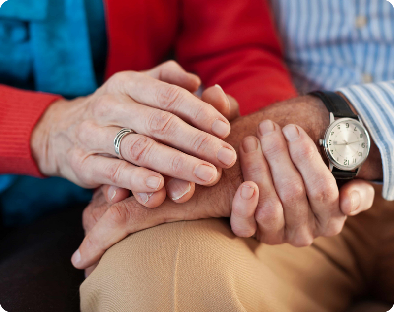 First symptoms of Parkinson's Disease, where a senior man checks his smartwatch before taking daily medication.