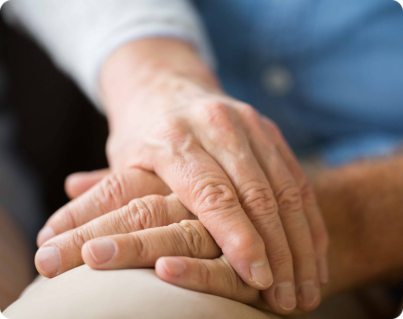 How hand tremor affects daily tasks, where a senior man with Parkinson's is using a walking cane at home.